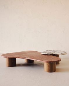 a skateboard sitting on top of a wooden table in front of a white wall