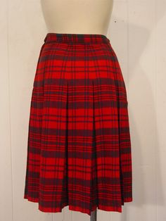 "Vintage 1950s skirt. Made of red and green plaid wool. Has a side zipper. No label. Size small. Actual measurements are: 26.5\" at the waist 41\" around the hips 25.5\" overall length. In very good condition." Vintage Plaid Full Skirt, Vintage Pleated Plaid Skirt, Scottish Style Fitted Plaid Pleated Skirt, Scottish Red Skirt For Fall, Vintage Plaid Pleated Skirt, Vintage Plaid Pleated Skirt For Fall, Fitted Vintage Plaid Skirt, Retro Plaid Full Skirt, Retro Full Skirt In Plaid