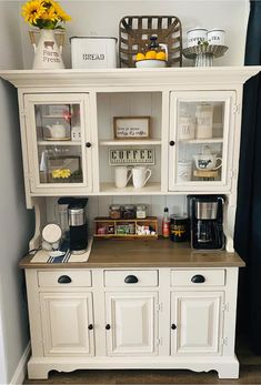 a white hutch filled with lots of clutter