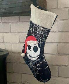 a stocking hanging from a brick wall with a skeleton wearing a santa claus hat