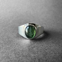 Natural Green Tourmaline Silver Ring - Green Chrome Tourmaline Ring Size 7 - Completely Handmade & Silver Gemstone: Green Tourmaline ( Chrome Tourmaline )  Metal: Pure and 925 Sterling Silver Stone Cut: Cabochon Stone Size: 8.5 mm x 6.9 mm - 0.33 in - 0.27 in Weight: 4.6 grams (23 carats) total weight of stone and silver. For ring orders, ring resizing is free. Chains are gifts for necklace orders..  Note: We don't use any filters for photos. The details may not be clear. Feel free to contact us Classic Tourmaline Jewelry With Polished Finish, Fine Jewelry Green Tourmaline Gemstones, Green Tourmaline Gemstones For Fine Jewelry, Green Tourmaline Ring For May Birthstone, Oval Tourmaline Ring For May Birthstone, Polished Tourmaline Jewelry For Anniversary, Classic Oval Tourmaline Jewelry, Oval Tourmaline Emerald Ring For Anniversary, Classic Oval Tourmaline Emerald Ring