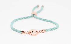 Discover the charm of our personalised initial bracelet, a delightful combination of a hand-stamped rose gold plated disc and an adjustable aqua/turquoise -coloured cord.  Featuring a hand-stamped initial on a plated metal disc, this custom bracelet embodies the essence of handmade jewelry.  Whether you're looking for a birthday gift for her or a special treat for yourself, this personalized bracelet is destined to be well received and is one of our most popular bracelets in our shop. Its adjust Initial Bracelet Silver, Gifts For Teenage Girls, Initial Bracelet Gold, Rose Gold Initial, Popular Bracelets, Monogram Bracelet, Slider Bracelet, Initial Bracelet