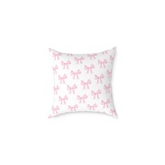 a pink pillow with bows on it