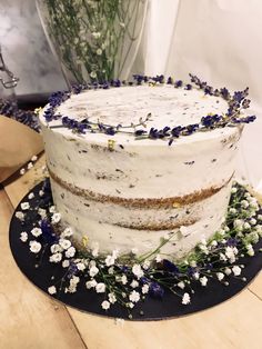 a cake with white frosting and blue flowers