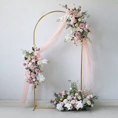 a wedding arch decorated with flowers and ribbons