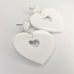 This classic double heart trapeze design has been given a retro feel with a simple white acrylic, they are lightweight and so stylish, perfect for any occasion. All orders are packaged with care. Each box includes tissue paper, a tealight and a KelZo postcard. Product details: Acrylic Approx 5.8cm Hypoallergenic stainless steel studs ****Colours may vary slightly from image due to resolution differences. Colour patterns may not match photographed item but will be cut from same piece/collection. Shapes and sizes may also vary due to the nature of handmade products.*** Care and Returns Please handle your KelZo Jewellery with care, as it is handmade and more fragile compared to mass market jewellery. Returns/replacements on pierced items are not accepted unless faulty, due to hygiene reasons. Mass Market, Double Heart, Simple White, White Acrylic, White Acrylics, Tealight, Handmade Products, Tissue Paper, Color Patterns