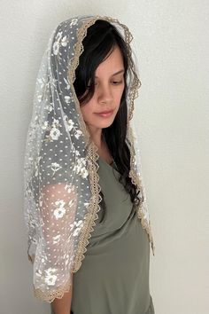 This soft floral tulle veil is cut in a rectangle shawl shape. The lace incorporates gold and white embroidery with tiny white dots throughout and is finished with an elegant gold trim. The women's rectangle shawl veil measures approximately 56" across and 19" wide.  A sewn-in metal snap comb may be requested free of charge.  Each veil is sold separately and is handmade to order. Please review the Shipping policy for processing times and FREE shipping options.  Veils are CPSIA compliant and cert Cap Veil, Chapel Veil, Tulle Veils, Soft Floral, Gold Lace, White Embroidery, Gold Trim, Veil, Shawl