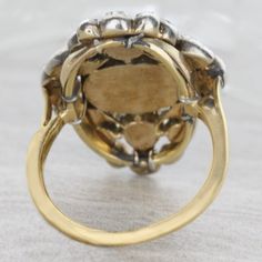 An original antique Georgian style diamond ring circa 1850's. This delightful treasure reflects light beautifully. The diamonds are foil backed set in a silver top and gold bottom. This item has no sign of change or repair. Details: SIZE: 4 Antique Diamond Ring Silver Top / Gold Bottom Original Condition No Sign Of Change Or Repair Foil Backed Diamonds Total Carat Weight: Approx. 3 carats Center Oval Diamond Total Carat Weight: 2 carats 4 Marquise = 0.40ct /4Round=0.45 /4Round=0.20ct /6Round=0.1 Antique Cluster Ring With Rose Cut Diamonds, Antique Gold Signet Ring With Rose Cut Diamonds, Antique Cluster Ring With Diamond Accents, Vintage Yellow Gold Signet Ring With Rose Cut Diamonds, Antique Gold Diamond Ring With Rose Cut Diamonds, Antique Hallmarked Diamond Ring, Antique Oval Hallmarked Diamond Ring, Antique Signet Ring With Diamond Accents, Antique Gold Cluster Ring