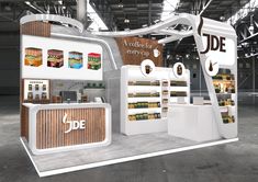 an exhibition stand with food items on display in the middle of a large warehouse building