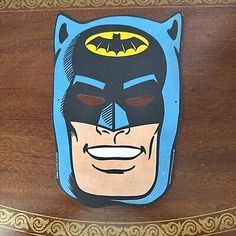 a wooden box with a batman face painted on it