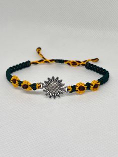 Cute macrame bracelet with a sunflower charm and braided sunflowers in a bright golden color, a leafy green color in between and your choice of knotted center or beaded center. Perfect as an accessory for spring and summer. The bracelets are adjustable with a sliding knot, so it can easily be taken on and off. I make it to order, so let me know your wrist size in the "personalization" tab, so I can make the perfect size for you. The standard size is about 9" long for most bracelets. Colors may vary depending on the screen you are using, so the color might be slightly different in real life. Adjustable Yellow Sunflower Design Jewelry, Casual Green Flower Shaped Jewelry, Casual Green Flower Jewelry, Casual Gold Flower Shaped Jewelry, Casual Gold Flower Jewelry, Adjustable Flower Friendship Bracelets For Beach, Green Beaded Bracelets With Adjustable Length, Adjustable Green Macrame Jewelry, Green Flower Friendship Bracelets