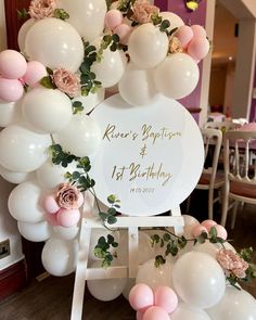 balloons and flowers decorate the entrance to a birthday party