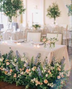 the table is set with flowers and candles for an elegant wedding breakfast or bridal party