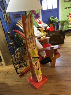 a lamp that is sitting on top of a wooden table in a room with surfboards