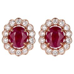 Introducing our Ruby Diamond Stud Earrings, exquisitely crafted in the romantic tones of 18K Rose Gold. These earrings feature the regal presence of rubies, totaling 1.36 carats, each stone radiating with a deep, crimson hue that captivates and enchants. The rubies are cut to perfection, showcasing their majestic color and splendid sparkle, making them the centerpiece of this elegant design. Surrounding the central gemstones is a halo of brilliant round-cut diamonds, weighing a total of 0.61 carats. These diamonds are chosen for their clarity and radiant shine, set to form a glistening frame that highlights the rubies' richness. The contrast between the vivid red of the rubies and the sparkling white of the diamonds creates a sophisticated and luxurious look that is timeless. The earrings Diamond Stud Earring, Rose Gold Earrings Studs, Rose Gold Studs, Ruby Rose, Matching Rings, Ruby Diamond, Diamond Stud, Modern Earrings, Dainty Earrings