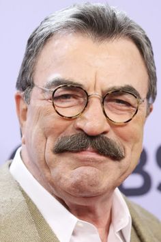 an older man with glasses and a mustache