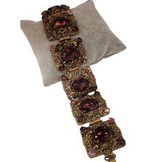 "Vintage Czech Glass & Filigree Elaborate Panel Bracelet (A4360) Size: 1.25\" x 8\" Condition: Very good vintage Era: Circa 1960s Signed: None Details: Beautiful, very elaborate panels, highly detailed bracelet. A few small stones look like they have a colored coating on them that is coming off. Please look at all the photos, as they are part of the description. I try my best to point out any flaws. Also please remember this is a preloved piece and may show signs of light wear, marks, scratches, etc. I will be posting a lot more jewelry, Keep checking back." Victorian Jeweled Bracelets For Formal Occasions, Antique Evening Bracelets, Antique Jeweled Bracelet For Formal Occasions, Victorian Bracelets With 17 Jewels For Evening, Vintage Jubilee Bracelet For Evening, Vintage Jeweled Jewelry For Evening, Vintage Jewelry With Jubilee Bracelet For Formal Occasions, Vintage Formal Bracelet With Intricate Design, Ornate Jeweled Bracelets For Formal Occasions