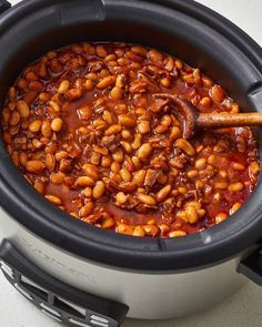 a crock pot filled with baked beans