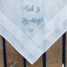 Unique hand embroidered 'Tad Y Briodferch' white cotton handkerchief. I have used blue 100% colour fast embroidery thread for the inscription on this gorgeous keepsake handkerchief. When ordering your Welsh language handkerchief please choose thread colour from drop down menu. This lovely keepsake is finished of with a natural mother of pearl heart shaped button. The handkerchief measures 41 cms x 41 cms. I would be happy to embroider a handkerchief for a bride in any language and a colour threa Father Of The Bride Wedding, Welsh Language, Pocket Handkerchief, Embroidered Handkerchief, Pearl Heart, Square Photos, Modest Fashion Outfits, Father Of The Bride, Wedding Groom