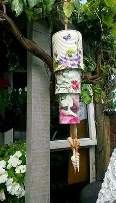 a wind chime hanging from a tree in a garden