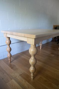 a wooden table sitting on top of a hard wood floor