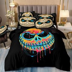 a bed with a black comforter and colorful skull on it