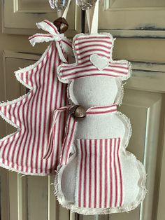 a red and white striped christmas ornament hanging from a door