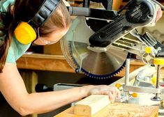 a woman using a circular saw to cut wood