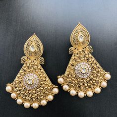 Pearl Kundan Stone Earrings/Blue Golden Chandbali Earrings/Statement Earrings/Golden Earrings/Ethnic Kundan Indian Chandbali/Indian Earrings Length: Approx. 3 Inches Comes with push back closure Made in Brass with Pearl beads Handmade Jewelry This pair of earring is made in Gold finish with Semi precious stone beads with Push back closure. Very Elegant and stylish, these earrings can be paired with any traditional Indian or Western Attire depending upon the occasion and the theme. Very lightweig Bollywood Style Chandbali Filigree Earrings, Bollywood Style Filigree Earrings For Festive Occasions, Gold Filigree Bollywood Earrings, Bollywood Filigree Earrings For Wedding, Festive Filigree Danglers, Festive Chandbali Danglers With Filigree Detail, Traditional White Pearl Earrings, Traditional White Pearl Pierced Earrings, Traditional Filigree Bridal Earrings For Festive Occasion