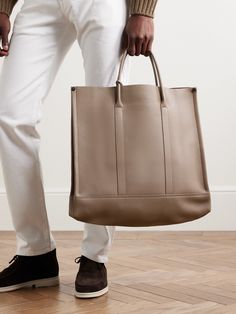 Loro Piana's 'Beam' tote bag is crafted to stand the test of time. Sleek and practical, it's been made in Italy from full-grain leather and is spacious enough to fit your laptop, a spare change of clothes and water bottle. Unfasten the side snaps for even more space. Large Modern Beige Bag, Luxury Everyday Bags In Vegetable Tanned Leather, Beige Calf Leather Bag With Dust Bag, Large Modern Beige Shoulder Bag, Modern Large Beige Shoulder Bag, Luxury Vegetable Tanned Leather Shoulder Bag With Double Handle, Large Elegant Beige Shoulder Bag, Beige Calf Leather Bags For Business, Beige Calf Leather Business Bags