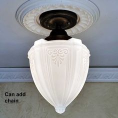 a white light fixture hanging from the ceiling