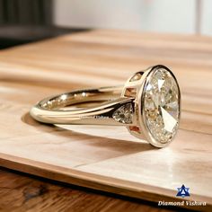 a diamond ring sitting on top of a wooden table