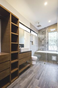 a bathroom with wooden cabinets and a white toilet