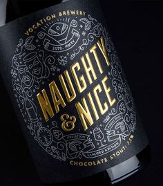 a close up of a bottle of wine on a black background with gold foil lettering