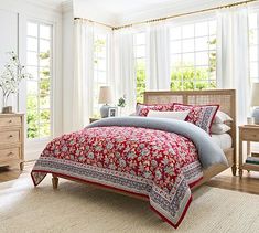 a bedroom with white walls and wooden furniture