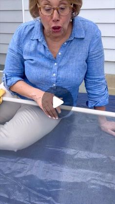 a woman is sitting on the ground and sticking her tongue out