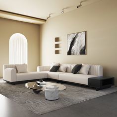 a living room with white couches and black accents