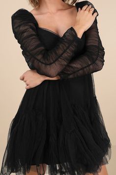 Charm the socks off everyone you meet in the Moon River Harena Black Tulle Plisse Long Sleeve Mini Dress! Gauzy tulle boasts a plisse-like texture as it shapes a sweetheart neckline framed by sheer long sleeves with puff shoulders and elasticized ruching along the center seam. The fitted bodice features a high, empire waist that tops a floaty mini skirt with a flouncy, tiered hem. Hidden back zipper/clasp. Fit: This garment fits true to size. Length: Mid-thigh. Size medium measures 32.5" from sh Tiered Mini Dress, Ruched Sleeve, In The Moon, Moon River, Adhesive Bra, Black Tulle, Stretch Dress, Long Sleeve Mini, Strapless Bra