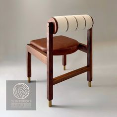 a wooden chair with a leather seat and arm rest