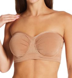 Soft strapless bra is knit for a comfortable stretch fit and easily changes shape to give you a perfect fit. Made of nylon and spandex. Seamless underwire cups are self lined with built-in pockets for removable padding, included. Cups are dual layers of 4-way stretch knit with ruching at the center and sides so that fit expands. Sweetheart neckline has a ribbed edge for flexible fit. Silicone grippers along the inner edge of the neckline (near center), keep cups from slipping. Ribbed 2-layer bas Strapless Seamless Shapewear, Stretch Tube Top With Removable Bra Pads, Strapless Nylon Tube Top With Built-in Bra, Micro-elastic Seamless Strapless Tube Top, Stretch Tube Top With Built-in Bra And Full Coverage, Micro-elastic Strapless Bra-friendly Tube Top, Micro-elastic Bandeau Bra With Built-in Support, Fitted Bandeau Sports Bra With Removable Pads, Nylon Tube Top With Built-in Bra