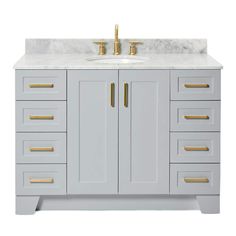 a white bathroom vanity with gold handles and drawers