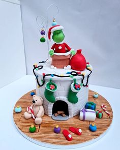 there is a cake that looks like the grinch in the chimney with decorations on it