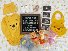 winnie the pooh baby shower gift set with bib and other items on a bed