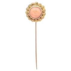 A fine vintage Etruscan Revival style stickpin. In 14 karat yellow gold. Bezel-set with a pink coral cabochon to the center surrounded by floriform gold wire work and granulation. Simply a wonderful stickpin! Date: 20th Century Overall Condition: It is in overall good, as-pictured, used estate condition. Condition Details: There are some bends to the pin stem and some light edge wear. Otherwise, there are some fine & light surface scratches and other signs of expected light wear consistent with age. Marks: Unmarked Fineness: Unmarked for gold fineness. Professionally tests at 14k. Gemstone Measurements: 1 Coral cabochon: ca. 8 mm diameter Measurements: Length: ca. 54mm Width: ca. 14mm Depth: ca. 9 mm Weight: ca. 2.1 g Items purchased from this dealer must delight you. Purchases may be retu Art Deco Brooch, Gold Sign, Gold And Pink, Coral Stone, Diamond Brooch, Bezel Set Diamond, Gold Brooches, Style Pink, Pink Coral