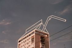 a tall building sitting on the side of a road next to power lines and telephone poles