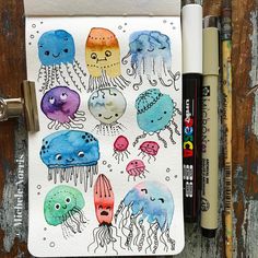 an art journal with watercolor drawings of jellyfish and other sea creatures on it