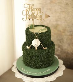 a birthday cake that is made to look like grass with a golf ball on top