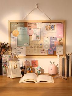 an open book sitting on top of a wooden desk