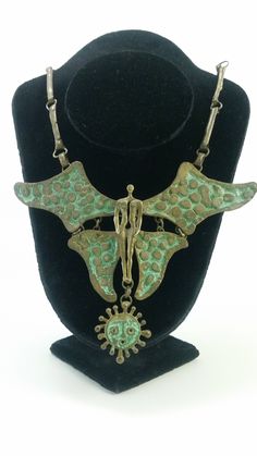 Description: Link style necklace featuring FAIRY, by Armando Lozano Ramirez, "Brutalist" movement, constructed of handcrafted bronze on brass with aquamarine wing detailing accented throughout, signed by the artist on the reverse. Dimensions: The size of the necklace is 40 cm Artist: Armando Lozano Ramírez (Mexico, 1950) Artist Biography: Armando Lozano Ramirez is a sculptor, artist and jewelry designer who has exhibited worldwide and is regarded as one of the world's finest avant-garde sculptor Brutalist Jewelry, Raw Artists, Art Jewelry Design, Artist Biography, Design Movements, Recycled Jewelry, Jewelry Designer, Style Necklace, Sculptor