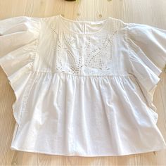 New Without Tags, Never Worn, Bought In Europe 100% Cotton Size 34 Eur, Fits Size 2-4 Us Beautiful Details On The Front Ruched Sleeves Feminine Top With Smocked Back And Flutter Sleeves, Fitted Tops With Smocked Bodice And Flutter Sleeve, Feminine Tops With Smocked Bodice And Flutter Sleeves, Feminine Top With Smocked Bodice And Flutter Sleeves, Cotton Blouse With Smocked Bodice, Relaxed Fit, Relaxed Fit Ruffle Sleeve Tops For Daywear, Summer Cotton Blouse With Smocked Bodice, Spring Tops With Smocked Back And Flutter Sleeve, Relaxed Fit Tops With Smocked Bodice And Puff Sleeves